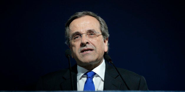 Greece's Prime Minister Antonis Samaras delivers his final campaign speech at the Taekwondo Indoor Stadium in southern Athens on Friday, Jan. 23, 2015. All opinion polls on Sunday's closely-watched national election agree: The radical left opposition Syriza party, which has vowed to rewrite the terms of Greece's international bailout, enjoys a lead of at least 4 percentage points over Prime Minister Antonis Samaras' conservatives. The sign on the podium reads ''We tell the truth.'' (AP Photo/Lefteris Pitarakis)