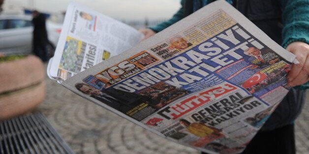 A photo taken on January 24, 2012 at Karakoy in Istanbul shows a man reading Turkish newpasper Hurriyet, with its front page reacting to the January 23 vote by the French Senate to ban the denial of the Armenian genocide. The law would impose a jail term and a 45,000 euro fine on anyone in France who denies that the 1915 massacre of Armenians constitutes genocide. The French lower house drew a first wave of Turkish ire last month, when it approved the bill which threatens with jail anyone in Fra