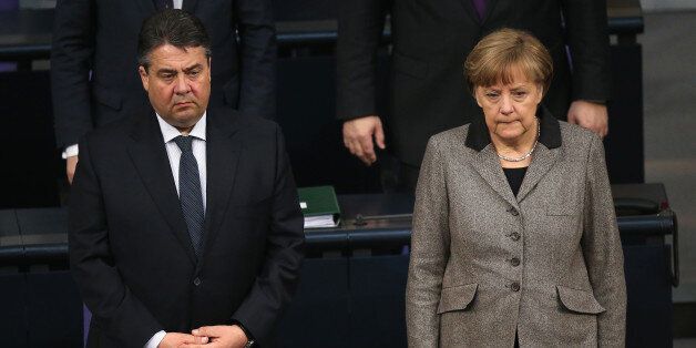 BERLIN, GERMANY - MARCH 26: German Chancellor Angela Merkel and Vice Chancellor and Economy and Energy Minister Sigmar Gabriel observe a moment of slience prior to a plenary session of the Bundestag to commemorate the victims of the crash of Germanwings flight 4U9525 on March 26, 2015 in Berlin, Germany. Of the 144 passengers and six flight crew 72 are confirmed as German citizens and all were killed in the crash in southern France that took place two days ago. (Photo by Sean Gallup/Getty Image