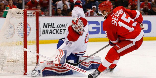 Detroit Red Wings center Riley Sheahan (15) scores on Montreal Canadiens goalie Ben Scrivens (40) in the second period of an NHL hockey game Thursday, March 24, 2016 in Detroit. (AP Photo/Paul Sancya)