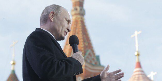 Russia's President Vladimir Putin gives a speech during a rally and a concert by the Kremlin Wall in central Moscow on March 18, 2015, to mark one year since he signed off on the annexation of Crimea in a epochal shift that ruptured ties with Ukraine and the West. AFP PHOTO / POOL / MAXIM SHIPENKOV (Photo credit should read MAXIM SHIPENKOV/AFP/Getty Images)