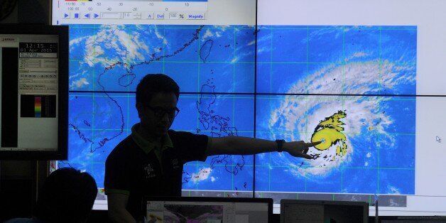 Meteorologists from the Philippine Atmospheric, Geophysical and Astronomical Services Administration (PAGASA) monitor and plot the direction of super typhoon Maysak at PAGASA headquarters in suburban Manila on April 1, 2015. The typhoon has already ravaged the Pacific islands and is expected to hit the Philippines this weekend. Government weather forecasters are hoping it will weaken before it slams into the northern part of the archipelago which is already frequently battered by typhoons. AFP