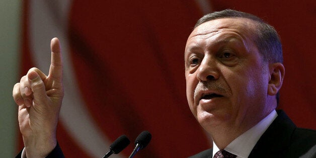 Turkey's President Recep Tayyip Erdogan addresses women during a meeting in Ankara, Turkey, Friday, March 6, 2015. It has become as easy to get jailed for offending the countryâs paramount leader, Erdogan, as it is in countries where laws forbid insults to royals. The trend alarms many people who have harbored hope for Turkey as a beacon of Western-style government in the Islamic world.(AP Photo)