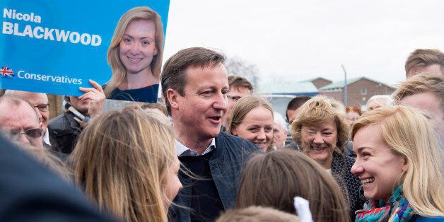 Britain's Prime Minister and Conservative party leader David Cameron, center left, and Conservative party candidate for Oxford West and Abingdon Nicola Blackwood, right, talk to members of the public as they campaign at Abingdon and Witney College in Abingdon, southern England, Saturday, April 4, 2015. Britain's political landscape is at its most fragmented in decades, and polls suggest no party will get a parliamentary majority on May 7. (AP Photo/Leon Neal, Pool)