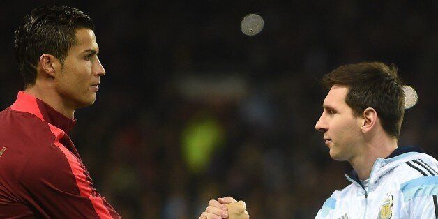 Argentina striker Lionel Messi (R) shakes hands with Portugal's striker Cristiano Ronaldo (L) ahead of kick off of the international friendly football match between the Argentina and Portugal at Old Trafford in Manchester on November 18, 2014. AFP PHOTO / PAUL ELLIS (Photo credit should read PAUL ELLIS/AFP/Getty Images)