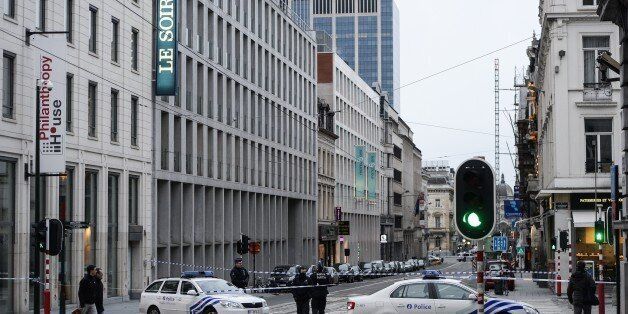 Police cordon off the street on January 11, 2015 in Brussels outside the offices of the Belgian newspaper Le Soir that republished cartoons from the French satirical magazine Charlie Hebdo after the building was evacuated following an anonymous bomb threat. The evacuation the French-language daily came as thousands of people marched through Brussels in solidarity with France following Islamist attacks on Charlie Hebdo and other sites.AFP PHOTO / BELGA / LAURIE DIEFFEMBACQ - BELGIUM OUT - (Photo credit should read LAURIE DIEFFEMBACQ/AFP/Getty Images)