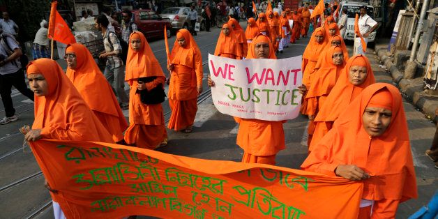 Nuns of Ananda Marga, a spiritual and social service organization, walk in a silent procession protesting the rape of an elderly nun at a convent in Ranaghat, in Kolkata, India, Tuesday, March 17, 2015. A nun in her 70s was gang-raped by a group of bandits when she tried to prevent them from committing a robbery in the Convent of Jesus and Mary School in West Bengal state's Nadia district, according to police. (AP Photo/Bikas Das)