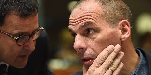 Greece's Finance Minister Yanis Varoufakis (R) speaks with a Greek delegation member during an economic and financial affairs council (ECOFIN) at the European Council in Brussels, on March 10, 2015. AFP PHOTO/Emmanuel Dunand (Photo credit should read EMMANUEL DUNAND/AFP/Getty Images)
