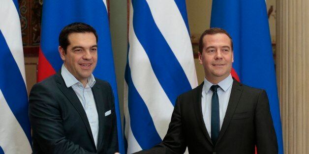 Russian Prime Minister Dmitry Medvedev, right, and Greek Prime Minister Alexis Tsipras shake hands during their meeting in Moscow, Thursday, April 9, 2015. Speaking Thursday, Tsipras reaffirmed his opposition to Western sanctions slapped on Russia last year and said his government helped block proposals to strengthen the sanctions. (AP Photo/Ivan Sekretarev)