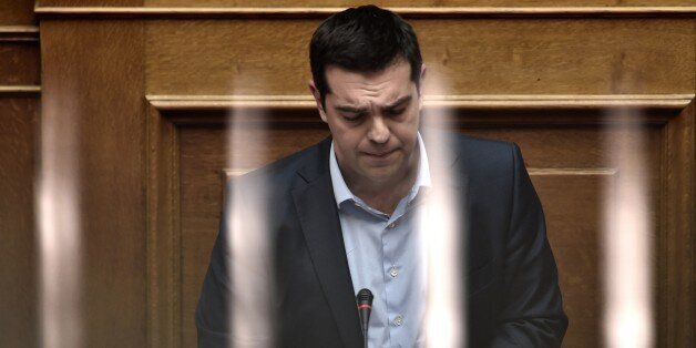 Greek Prime Minister Alexis Tsipras addresses a parliament session in Athens on March 30, 2015. The EU warned Monday that Greece and its creditors had yet to hammer out a new list of reforms despite talks lasting all weekend aimed at staving off bankruptcy and a euro exit. AFP PHOTO / ARIS MESSINIS (Photo credit should read ARIS MESSINIS/AFP/Getty Images)