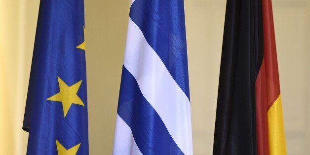 (L-R) EU, Greek, German flags are pictured on February 5, 2015 at the Finance ministry in Berlin. The new Greek finance minister's stop in Berlin follows a high-stakes visit to ECB headquarters in Frankfurt to try to drum up support for the new anti-austerity government's debt relief bid. AFP PHOTO / ODD ANDERSEN (Photo credit should read ODD ANDERSEN/AFP/Getty Images)