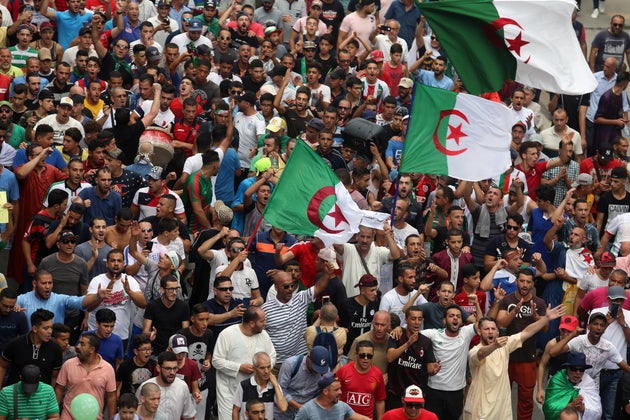 Demonstrators shout slogans during a protest to reject the Algerian election announcement for December,...
