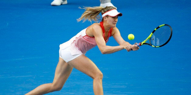 Eugenie Bouchard of Canada makes a backhand return to Agnieszka Radwanska of Poland during their second round match at the Australian Open tennis championships in Melbourne, Australia, Wednesday, Jan. 20, 2016.(AP Photo/Vincent Thian)