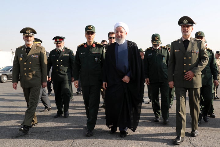 President Hassan Rouhani (center) arrives for a military parade ceremony marking the 39th anniversary of outset of Iran-Iraq war. 