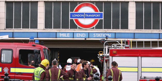 Firefighters stand outside Mile End tube station, London, after a tube derailed on the westbound Central line between Mile End and Bethnal Green Thursday July 5, 2007. One person was injured in the accident and police have said the incident was not terror related. (AP Photo/Simon Dawson)
