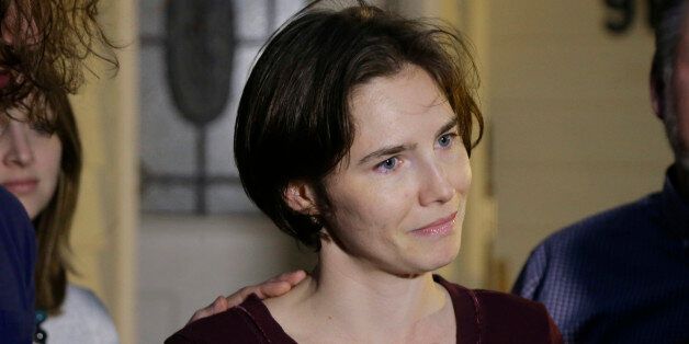 Amanda Knox talks to reporters outside her mother's home, Friday, March 27, 2015, in Seattle. Earlier in the day, Italy's highest court overturned the murder conviction against Knox and her ex-boyfriend over the 2007 slaying of Knox's roommate in Italy. (AP Photo/Ted S. Warren)