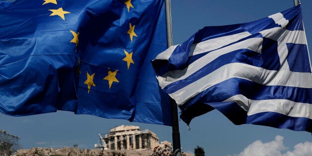 An EU and a Greek flag fly in front of the ancient Parthenon temple, in Athens, on Wednesday, April 9, 2014. Greece announced Wednesday it was returning to international bond markets for the first time in four years amid growing signs of confidence in the country at the forefront of the European debt crisis. (AP Photo/Petros Giannakouris)