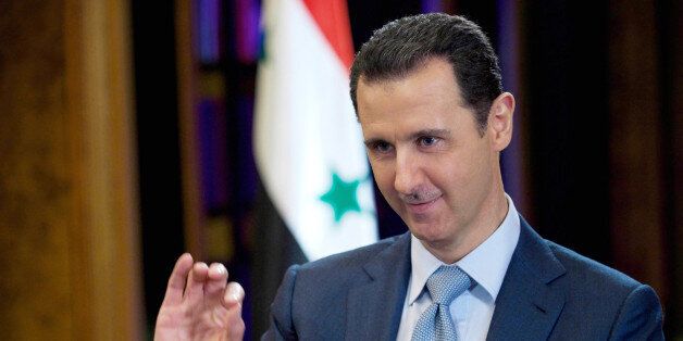 FILE - In this Tuesday, Feb. 10, 2015 file photo released by the Syrian official news agency SANA, Syrian President Bashar Assad gestures during an interview with the BBC, in Damascus, Syria. Assad says he would be