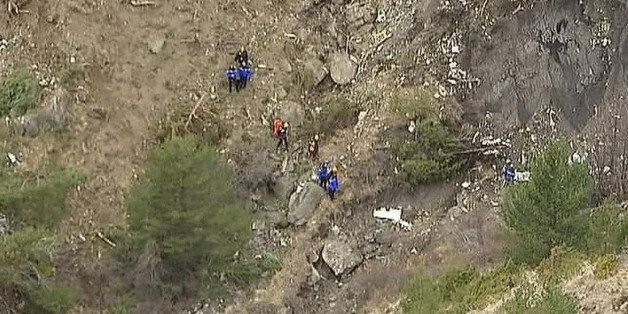 In this image made from TV, rescue workers look amongst debris over the area after a Germanwings Airbus 320 crashed near Seyne-les-Alpes in the French Alps, Tuesday, March 24, 2015. A Germanwings passenger jet carrying at least 150 people crashed Tuesday in a snowy, remote section of the French Alps, sounding like an avalanche as it scattered pulverized debris across the mountain. (AP Photo/TF1)