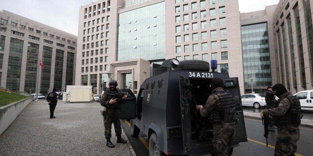 Members of special security forces stand outside the main courthouse in Istanbul, Turkey, Tuesday, March 31, 2015. Turkish news agencies say that members of a banned leftist group have taken a chief prosecutor hostage in his office inside the courthouse. State-run Anadolu Agency and state television, TRT, identified the prosecutor as Mehmet Selim Kiraz. He is the prosecutor investigating the death of a teenager who was hit by a police gas canister fired during nationwide anti-government protests