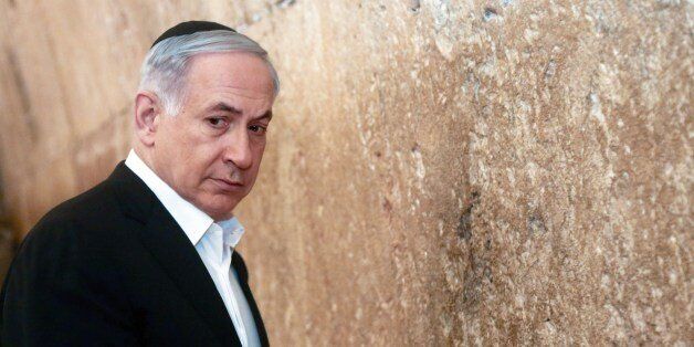 Israeli Prime Minister Benjamin Netanyahu looks on before praying at the Western Wall, the holiest site where Jews can pray, in Jerusalem's Old City, Saturday Feb. 28, 2015. (AP Photo/Marc Sellem, Pool)