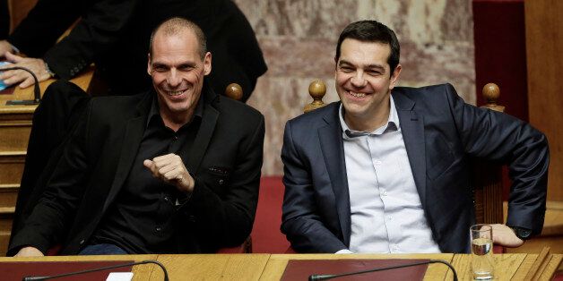 Greece's Prime Minister Alexis Tsipras and Greece's Finance Minister Yanis Varoufakis smile during a Presidential vote in Athens, on Wednesday, Feb. 18, 2015. Greeceâs parliament has elected conservative law professor and veteran politician Prokopis Pavlopoulos as the countryâs next president, after he received support from the new left-wing government and main center-right opposition party.(AP Photo/Petros Giannakouris)