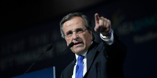 Greece's Prime Minister Antonis Samaras delivers his pre-election speech at the Taekwondo Indoor Stadium in southern Athens on Friday, Jan. 23, 2015. All opinion polls on Sunday's closely-watched national election agree: The radical left opposition Syriza party, which has vowed to rewrite the terms of Greece's international bailout, enjoys a lead of at least 4 percentage points over Prime Minister Antonis Samaras' conservatives. (AP Photo/Lefteris Pitarakis)