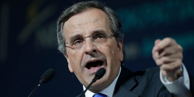 Greece's Prime Minister Antonis Samaras delivers his final campaign speech at the Taekwondo Indoor Stadium in southern Athens on Friday, Jan. 23, 2015. All opinion polls on Sunday's closely-watched national election agree: The radical left opposition Syriza party, which has vowed to rewrite the terms of Greece's international bailout, enjoys a lead of at least 4 percentage points over Prime Minister Antonis Samaras' conservatives. (AP Photo/Lefteris Pitarakis)