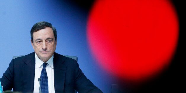 President of European Central Bank Mario Draghi speaks during a news conference in Frankfurt, Germany, Thursday, Dec.4, 2014, following a meeting of the ECB governing council. Draghi will assess the state of the economy at the news conference after the bank decided to leave its main interest rate at 0.05 percent. The red light is from a TV camera. (AP Photo/Michael Probst)