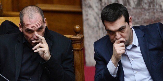 Greek Prime Minister Alexis Tsipras (R) sits along side Finance Minister Yianis Varoufakis during the vote for the president, at the Greek parliament in Athens, on February 18, 2015. Greece's parliament elected pro-European conservative Prokopis Pavlopoulos as the country's new president, a move calculated to bolster the hard-left government in its critical EU bailout talks. AFP PHOTO / LOUISA GOULIAMAKI (Photo credit should read LOUISA GOULIAMAKI/AFP/Getty Images)