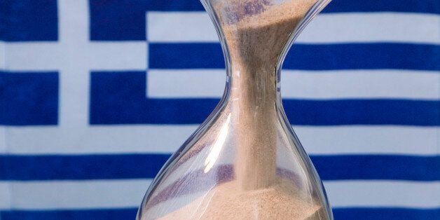 GERMANY, BONN - MARCH 17: Sand glass and a Greek flag.Our picture shows a running sand glass and the Greek flag. (Photo by Ulrich Baumgarrten via Getty Images)