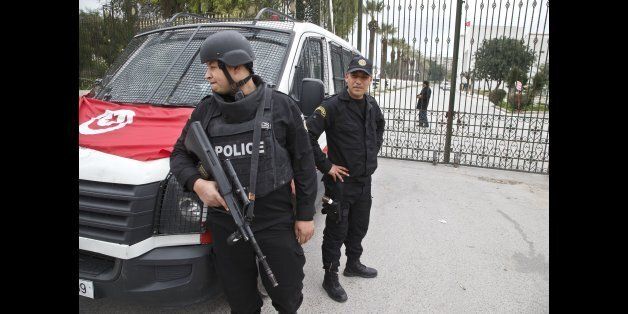 Tunisian police officers guard the entrance of the National Bardo museum in Tunis, Tunisia, Saturday March 21, 2015. The two extremist gunmen who killed 21 people at a museum in Tunis trained in neighboring Libya before caring out the deadly attack, a top Tunisian security official said. (AP Photo/Michel Euler)