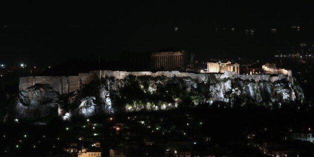 This picture shows the ancient Temple of Parthenon atop Acropolis hill in partial darkness during the Earth Hour initiative in Athens on March 28, 2015. Millions are expected to take part around the world in the annual event organised by conservation group WWF, with hundreds of well-known sights set to plunge into darkness. AFP PHOTO / ANGELOS TZORTZINIS (Photo credit should read ANGELOS TZORTZINIS/AFP/Getty Images)