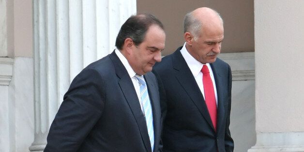 Newly elected Greek Prime Minister George Papandreou, right, escorts outgoing Prime Minister Costas Karamanlis after handing over power in Athens on Thursday, Oct. 6, 2009. Papandreou, a 57-year-old former foreign minister and scion of one of Greece's top political families, now follows in the footsteps of his father Andreas and grandfather and namesake George, both of whom served several terms as prime ministers. (AP Photo/ Petros Giannakouris)