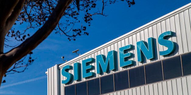 Siemens Industry Inc. signage is displayed outside of the company's manufacturing facility in Sacramento, California, U.S., on Thursday, Feb. 12, 2015. The U.S. Federal Reserve is scheduled to release industrial production figures on Feb. 18. Photographer: David Paul Morris/Bloomberg via Getty Images