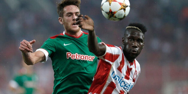 Olympiakos' Arthur Masuaku, right, Athletic Bilbao's Ibai Gomez, fight, for the ball during a friendly soccer match in Karaiskaki stadium, Piraeus, near Athens, Wednesday, Aug. 13, 2014. (AP Photo/Petros Giannakouris)