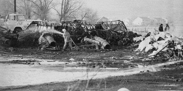 FILE - In this Jan. 21, 1985, file photo, a fireman hoses down an aircraft wreckage, Galaxy Airlines Flight 203 crashed on take off from Cannon International Airport in Reno. The lone survivor of the 1985 airplane crash that killed 70 people who were returning from a Super Bowl junket says he can't bring himself to attend a memorial on the 30th anniversary of the disaster. George Lamson Jr. was 17 when flight crashed. (AP Photo/Sal Veder, File)