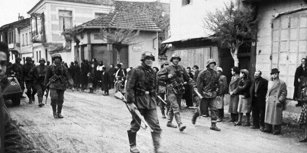A squad of German soldiers pass through a Greek village, during the occupation of Greece, in May 1941. (AP Photo)