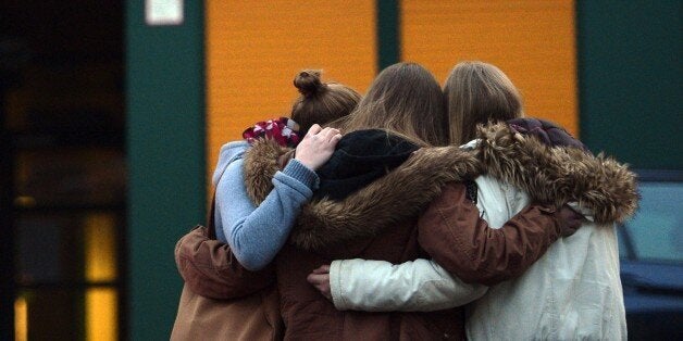 Students gather at a memorial of flowers and candles in front of the Joseph-Koenig-Gymnasium secondary school in Haltern am See, western Germany on March 24, 2015, from where some of the Germanwings plane crash victims came. Sixteen German teenagers and two teachers on a school exchange trip were assumed to be among the 150 dead in the crash of a passenger jet in the French Alps, officials said. The head of low-budget airline Germanwings said there were 144 passengers and six crew on the Airbus A320 that crashed in the French Alps en route to Duesseldorf from Barcelona. AFP PHOTO / SASCHA SCHUERMANN ALTERNATIVE CROP (Photo credit should read SASCHA SCHUERMANN/AFP/Getty Images)