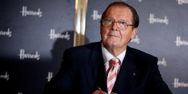British Actor Roger Moore poses for photographs as he signs books at the launch of his book Bond on Bond, at Harrods department store in London on October 11, 2012. In his book Moore details gadgets, cars and villains of 50 years of James Bond. AFP PHOTO / ANDREW COWIE (Photo credit should read ANDREW COWIE/AFP/GettyImages)