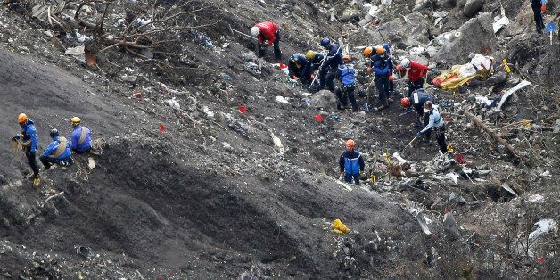 FILE - In this Thursday, March 26, 2015 file photo, rescue workers work at debris of the Germanwings jet at the crash site near Seyne-les-Alpes, France. Investigators recovering remains from all 150 people aboard a German passenger jet that crashed into the Alps have accelerated their timeframe for identifying and matching their DNA _ whether that be from a body part or only a shred of skin. (AP Photo/Laurent Cipriani, File)