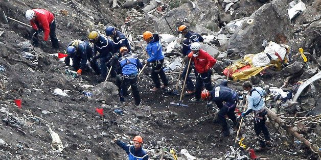 Rescue workers work on debris of the Germanwings jet at the crash site near Seyne-les-Alpes, France, Thursday, March 26, 2015. The co-pilot of the Germanwings jet barricaded himself in the cockpit and âintentionallyâ rammed the plane full speed into the French Alps, ignoring the captainâs frantic pounding on the cockpit door and the screams of terror from passengers, a prosecutor said Thursday. In a split second, he killed all 150 people aboard the plane. (AP Photo/Laurent Cipriani)