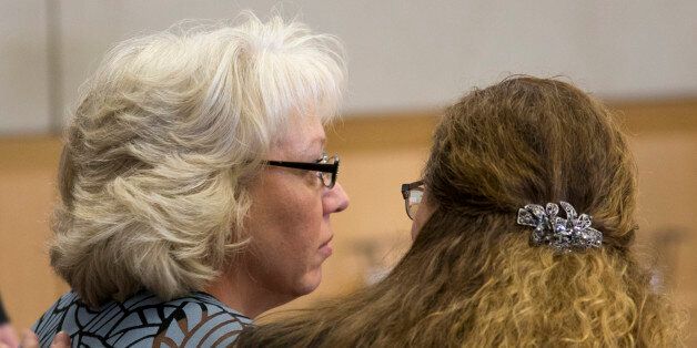 Debra Milke, left, sits in court with her attorney, Lori Voepel during a hearing, Monday, March 23, 2015, in Marcopa County Superior Court in Phoenix. Judge Rosa Mroz dismissed murder charges Monday against Milke without prejudice and ordered a probation officer to remove a monitoring device from her ankle. Milke, 51, spent 23 years on Arizona death row for the December 1989 murder of her four-year-old son, Christopher. (AP Photo/The Arizona Republic, Mark Henle, Pool)