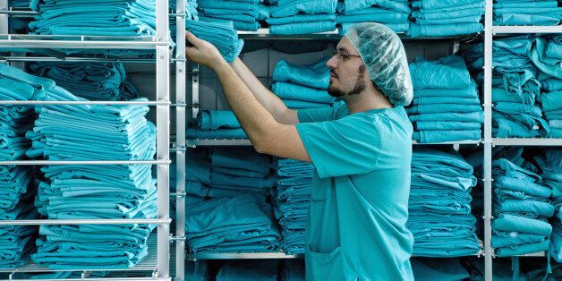 Stacking shelves with scrubs in hospital laundry