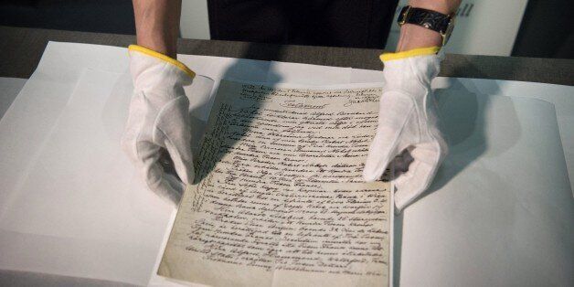 Senior Curator at the Nobel Museum, Margrit Wettstein presents the testament of Swedish scientist Alfred Nobel during a press meeting on March 12, 2015 prior to the opening of the exhibition 'Legacy' at the Nobel Museumin Stockholm, Sweden. Alfred Nobel's will creating the prestigious awards that bear his name will go on public display for the first time in the exhibition 'Legacy' that will start on March 13, 2015. AFP PHOTO / TT NEWS AGENCY/ JESSICA GOW +++ SWEDEN OUT (Photo credit should read JESSICA GOW/AFP/Getty Images)