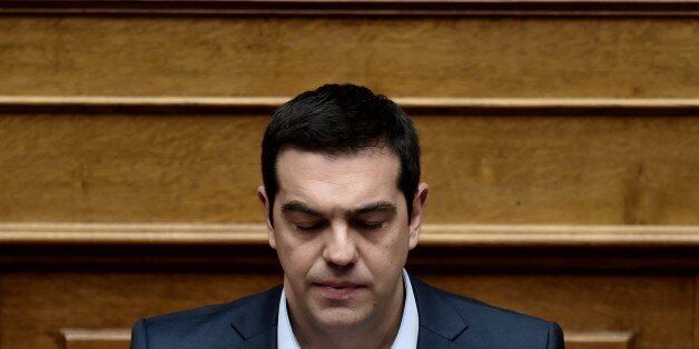 Greek Prime Minister Alexis Tsipras attends a parliament session in Athens on March 30, 2015. The EU warned Monday that Greece and its creditors had yet to hammer out a new list of reforms despite talks lasting all weekend aimed at staving off bankruptcy and a euro exit. AFP PHOTO / ARIS MESSINIS (Photo credit should read ARIS MESSINIS/AFP/Getty Images)