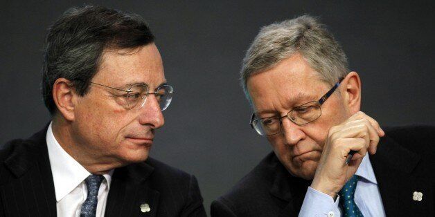 Mario Draghi, European Central Bank President, left, talks with Klaus Regling, Managing Director European Stability Mechanism/EFSF during the Informal meeting of ECOFIN Ministers in Dublin Castle, Ireland, Friday, April 12, 2013. (AP Photo/Peter Morrison)