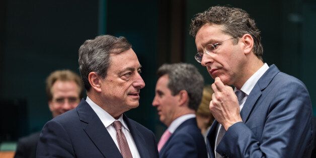 Dutch Finance Minister Jeroen Dijsselbloem, right, talks with European Central Bank Governor Mario Draghi during a meeting of eurogroup finance ministers at the European Council building in Brussels, Monday March 9, 2015. (AP Photo/Geert Vanden Wijngaert)