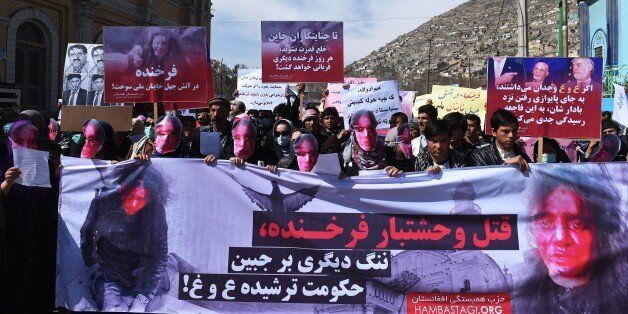 Afghan members of the Solidarity Party of Afghanistan wearing masks bearing an impression of the bloodied face of a woman who was lynched by a mob chant slogans during a protest against the attack in Kabul on March 23, 2015. Afghan woman who was beaten to death and set on fire by a mob for allegedly burning a copy of the Koran. The body of Farkhunda, 27, who was lynched on March 19 by an angry mob in central Kabul, was carried to the graveyard by women amid crowds of men, an AFP reporter said, a rare act of protest in a male-dominated society. AFP PHOTO / SHAH Marai (Photo credit should read SHAH MARAI/AFP/Getty Images)