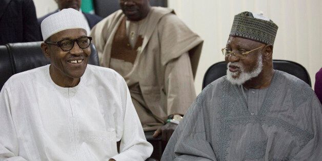 Nigerian former Gen. Muhammadu Buhari, left, and former Nigeria President Abdulsalami Abubakar, right, watch the announcement of presidential election results in Abuja, Nigeria, Tuesday, March 31, 2015. Nigerian President Goodluck Jonathan conceded defeat to Buhari, a 72-year-old former military dictator, who was elected in a historic transfer of power following the nation's most hotly contested election ever. (AP Photo/Bayo Omoboriowo)